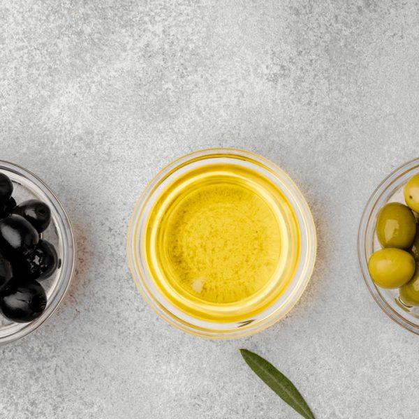 bowls-with-black-and-green-olives-and-olive-oil-on-gray-background